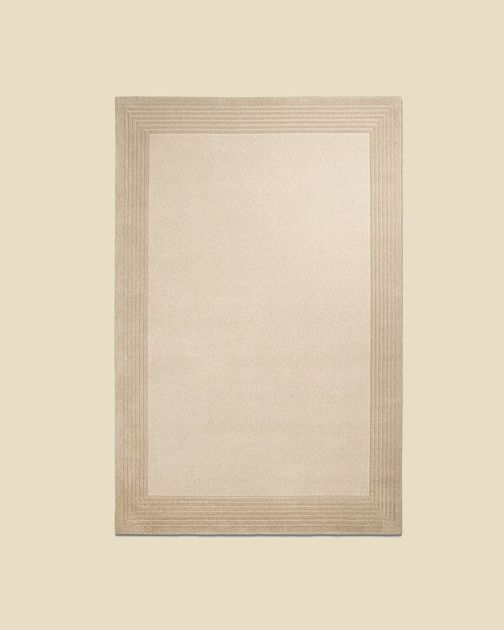 Tapis en laine Micadoni Kotto en beige, cadre cannelé