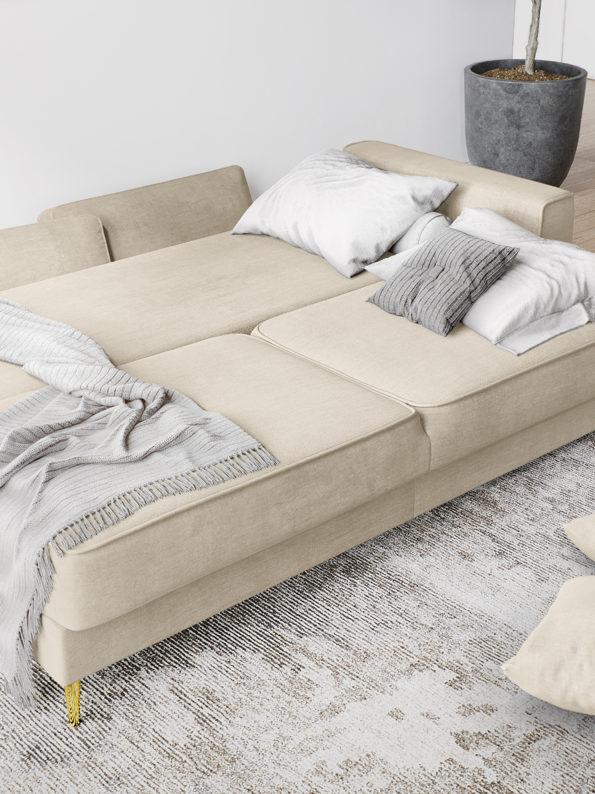 beige-sleeper-sofa-in-open-position-with-pillows-scattered