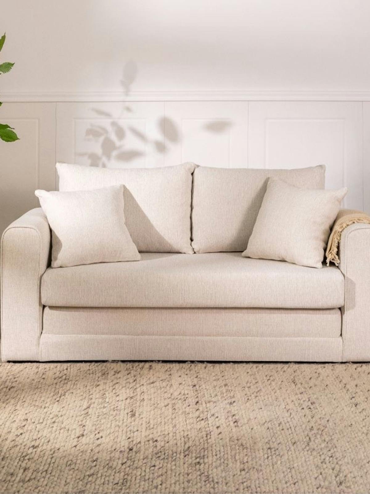 Dom w stylu wabi sabi to beżowa kanapa i minimalistyczne dekoracje
