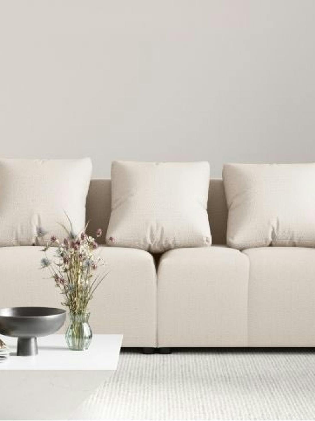 Duża beżowa sofa z przeszyciami i poduszkami to najlepsza sofa do każdego wnętrza