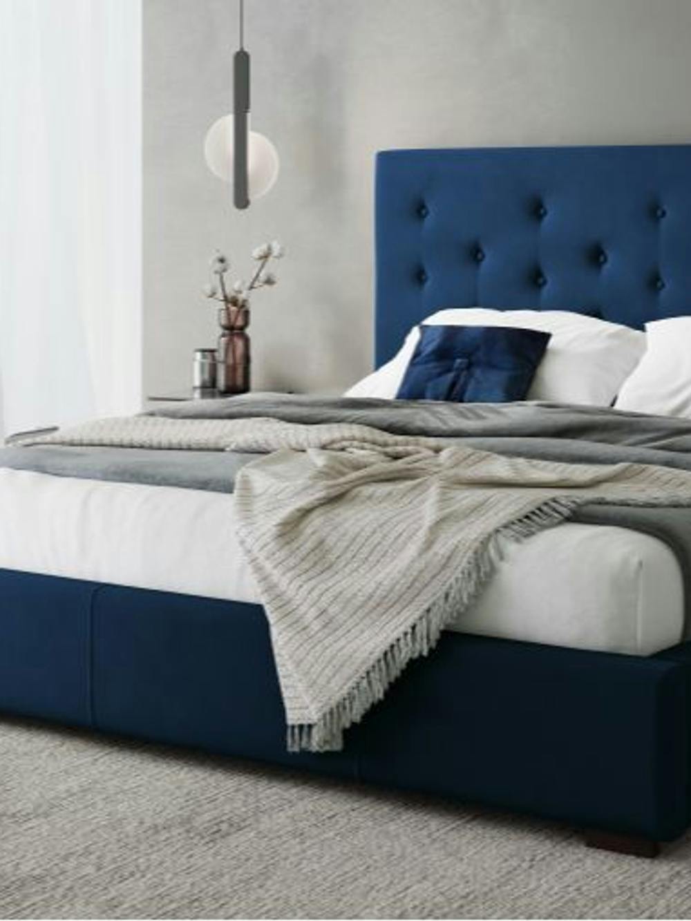 blue-bedframe-covered-with-white-cushions-in-a-white-bedroom